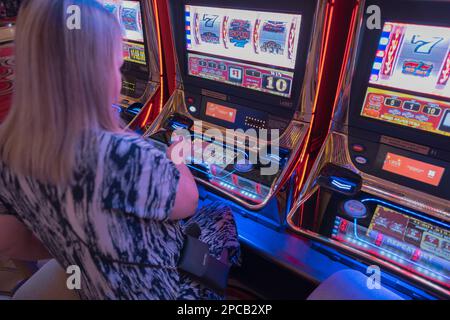 Primo piano di una donna che gioca a slot machine nel casinò dell'hotel di Las Vegas. Las Vegas. STATI UNITI. Foto Stock