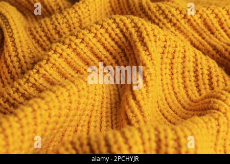 Bello tessuto a maglia arancione come sfondo, primo piano Foto Stock