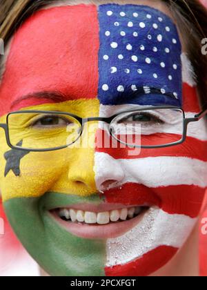 A fan wears competing teams face paint as she waits for the start of the USA vs Ghana World Cup Group E soccer match at the Franken Stadium in Nuremberg, Germany, Thursday, June 22, 2006. Other teams in Group E are Italy and Czech Republic. (AP Photo/Jorge Saenz) ** MOBILE/PDA USAGE OUT **