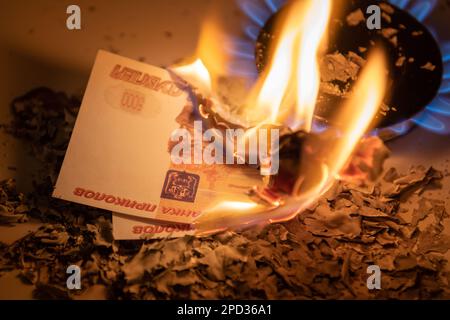 Banconote in rubli brucianti. Elevate bollette di gas naturale. Denominazione diversa delle fatture. Primo piano. Concetto di finanza. Sfondo e struttura dei soldi. Foto Stock