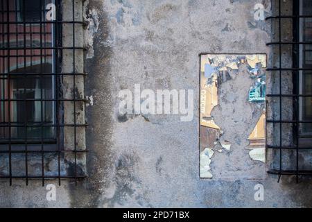 Uno specchio rotto su una parete industriale in cemento Foto Stock