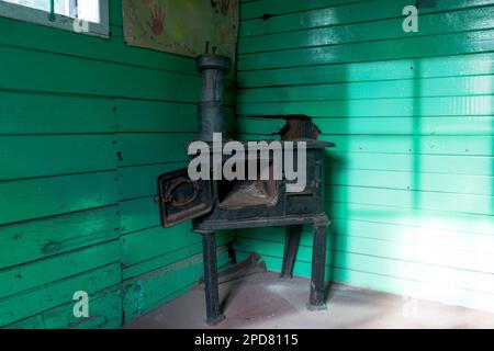 fotografia di vecchia stufa a legna abbandonata o a carbone, in stanza di legno Foto Stock