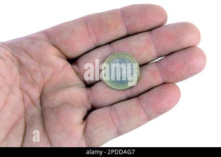 Una moneta europea in una mano, l'Europa Foto Stock