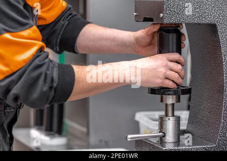 chiuso con il coperchio di lattine in una tappatrice automatica in una fabbrica di birra Foto Stock