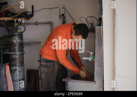 Il meccanico si lava le mani dopo la riparazione dell'auto. L'operaio si lava le mani Foto Stock