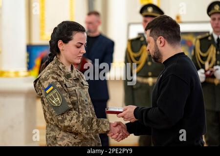 Kiev, Ucraina. 14th Mar, 2023. Il presidente ucraino Volodymyr Zelenskyy, a destra, assegna una medaglia al tenente Junior del servizio medico Alina Mykhailova, a sinistra, dei Lupi da Vinci durante una cerimonia il giorno del Volontariato ucraino presso la Sala Bianca degli Eroi del Palazzo Mariinsky, 14 marzo 2023 a Kyiv, Ucraina. Credit: Foto piscina/Ufficio stampa presidenziale ucraino/Alamy Live News Foto Stock