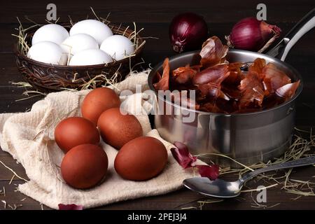 Colorare le uova di pollo per Pasqua con la buccia di cipolla. Foto Stock