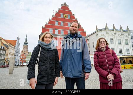 Greifswald, Germania. 17th Mar, 2023. Gli attivisti del movimento 'ultima generazione' Claudia Röseler (l-r), Theodor Schnarr e Marie Kamischke si trovano sul mercato di fronte al municipio. Il sindaco di Greifswald, Fassbinder, ha assicurato agli attivisti del clima il sostegno dell'"ultima generazione" nella loro richiesta di un consiglio dei cittadini sulla protezione del clima. Credit: Stefan Sauer/dpa/Alamy Live News Foto Stock