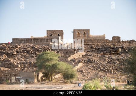 Le mura di pietra sbriciolanti e le rovine dell'antica città desertica di Oudane, patrimonio dell'umanità dell'UNESCO in Mauritania. Foto Stock