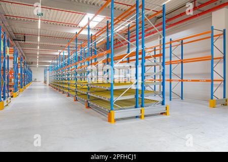 Scaffalatura rack Gravity Flow nel magazzino di distribuzione Foto Stock