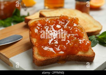 Toast deliziosi con marmellata a bordo, primo piano Foto Stock