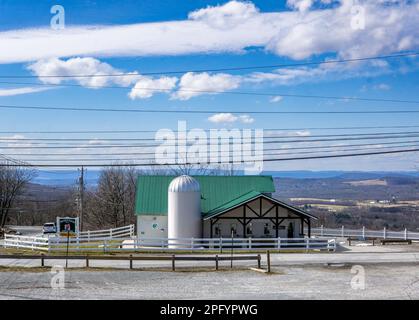 Warwick, NY - USA - 18 Marzo 2023 Vista orizzontale dell'iconica Bellvale Farms Creamery in stile fienile, un negozio di gelati fatti in casa, tavolo da picnic Foto Stock