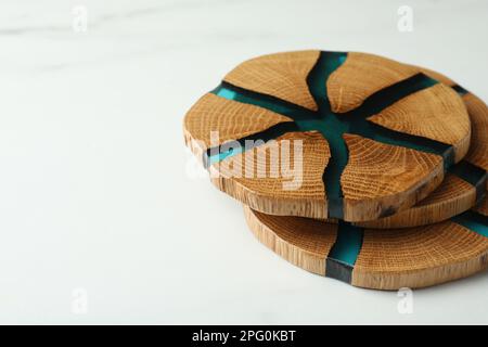 Eleganti montagne russe in legno su un tavolo in marmo bianco, spazio per il testo Foto Stock