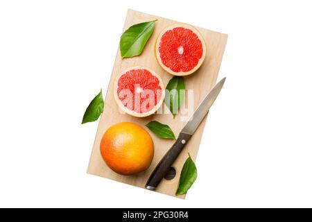 Fette di pompelmo di frutta fresca isolate su fondo bianco. Vista dall'alto. Copia spazio. concetto estivo creativo. Metà dell'agrume in minimo piatto adagiare con il cop Foto Stock