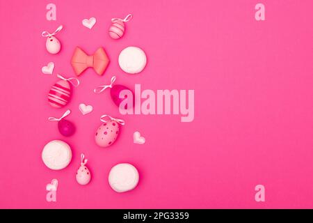 Sfondo di Pasqua in rosa con uova, cuori, marshmallow e fiocco rende perfetto lo spazio di copia a tema pasquale Foto Stock