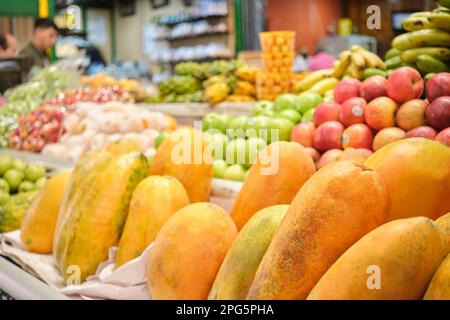 Papaya, pawpaws, o papaws ed altri frutti tropicali per la vendita ad una stalla di mercato di verdure. Foto Stock