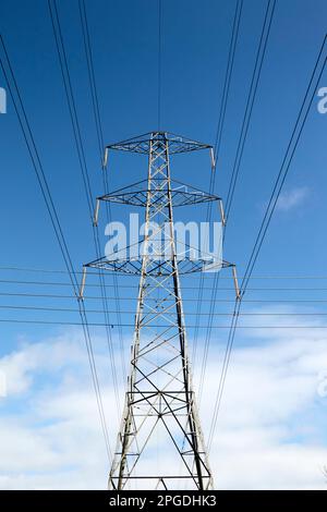 Cavi elettrici ad alta tensione sulla torre di trasmissione che attraversano i cavi telefonici nell'area rurale di Newtownabbey, Irlanda del Nord, Regno Unito Foto Stock