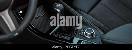 Steering wheel and interior of the BMW X1 25e in the M Sport version. View from the rear seat. Katowice, Poland, 31.07.2021 Foto Stock