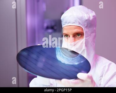 Ingegnere che esamina il chip di wafer in laboratorio Foto Stock