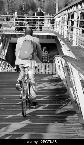 PARIGI, FRANCIA - 12 MARZO 2016: Ciclista (persone irriconoscibili) sul ponte pedonale Solferino sul fiume Senna vicino al Museo di Orsey. Bianco e nero Foto Stock