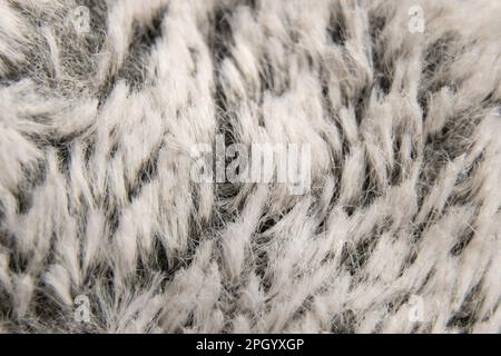 pelliccia artificiale isolamento grigio come sfondo macro foto Foto Stock