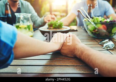 Grazie a Most High per averci riunito oggi. Primo piano di un gruppo irriconoscibile di giovani amici che tengono le mani insieme intorno a. Foto Stock