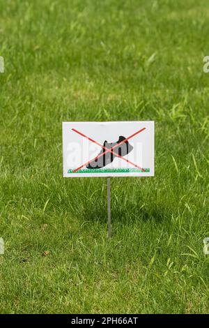 Non camminare sul segno di erba posto su un prato verde bello. Foto Stock