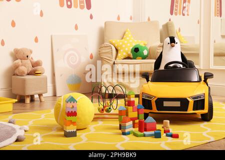 Auto elettrica per bambini e altri giocattoli in sala giochi Foto Stock