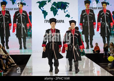 Mosca, Russia. 26th marzo 2023. I modelli presentano i costumi nazionali di Cossack (regione di Kuban) su una pista come parte dello spettacolo 'bordi del mondo' al festival di moda per bambini della settimana della moda per bambini al negozio centrale per bambini di Lubyanka a Mosca, Russia Foto Stock