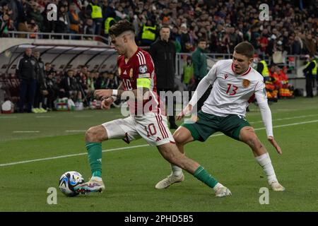 Budapest. 27th Mar, 2023. Dominik Szoboszlai (L) dell'Ungheria vies con Yoan Stoyanov della Bulgaria durante la partita di qualificazione UEFA euro 2024 del Gruppo G tra Ungheria e Bulgaria a Budapest, in Ungheria, il 27 marzo 2023. Credit: Attila Volgyi/Xinhua/Alamy Live News Foto Stock