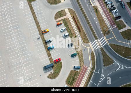 parcheggio auto con posti vacanti vicino alla strada cittadina. infrastrutture urbane moderne. vista aerea dall'alto. Foto Stock