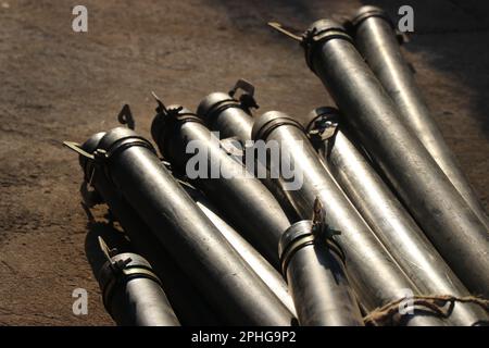 I tubi in HDPE utilizzati per il trasporto di acqua con proprietà anticorrosive e un morsetto metallico per la giunzione di altri tubi tenuti su un palo Foto Stock