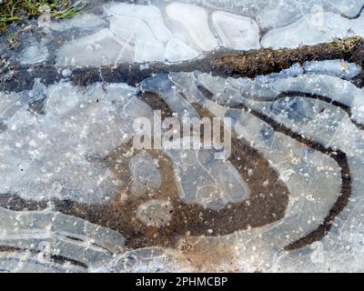 La bellezza è intorno a noi. Ma a volte dovete guardare in giù. Un recente periodo sostenuto di temperature subzero ha portato a stagni ghiacciati e pozze attraverso Foto Stock