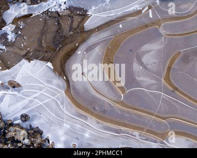 La bellezza è intorno a noi. Ma a volte dovete guardare in giù. Un recente periodo sostenuto di temperature subzero ha portato a stagni ghiacciati e pozze attraverso Foto Stock