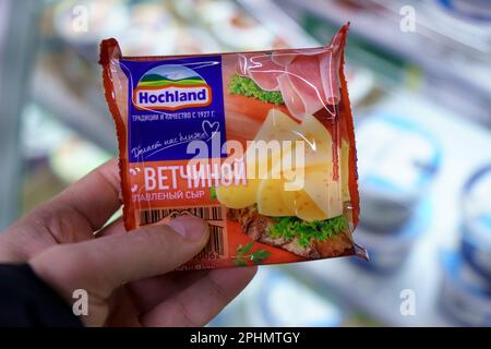 Tyumen, Russia-17 marzo 2023: Confezione di formaggio cremoso a fette Hochland con prosciutto. Foto Stock