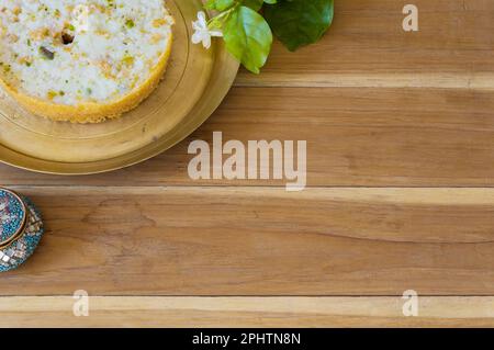 Ghewar o ghevar è un dolce tradizionale di rajasthan. È fatto di latte, farina, ghee e zucchero. Frutta secca e panna malai in cima. E' servito in br Foto Stock