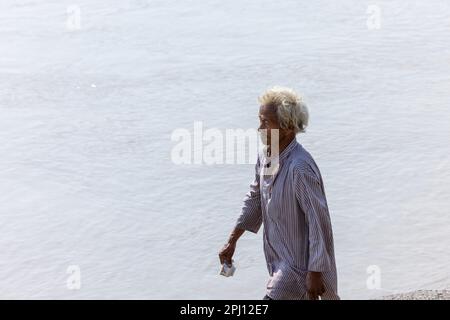 Santo Rishikesh, Ritratto di vecchio brahmin maschio non identificato a piedi vicino al fiume ganges a rishikesh durante la mattina d'inverno indossando abiti tradizionali. Foto Stock