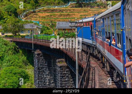 Nuwara Eliya, Sri Lanka, 30 gennaio 2022: Treno che si snoda su una pista collinare tra le piantagioni di tè in Sri Lanka. Foto Stock