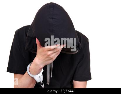 Triste giovane uomo in manette isolato sullo sfondo bianco Foto Stock