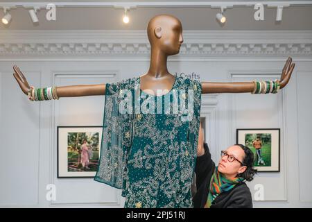 Londra, Regno Unito. 31st Mar, 2023. Il personale della Galleria apporta modifiche al mini abito di ispirazione sari, verde, con tecniche di ricamo asiatiche. William Morris Gallery svela una grande mostra del fashion designer Ashish. Ashish Gupta, è un fashion designer la cui firma è sequins e beads, utilizzando il suo patrimonio indiano. La sua etichetta omonima si ispira alla sua eredità, con pezzi indossati da Madonna, Lady Gaga, taylor Swift e molti altri.Over 60 disegni degli ultimi 20 anni saranno in mostra fino al 10 settembre 2023. Credit: Imageplotter/Alamy Live News Foto Stock