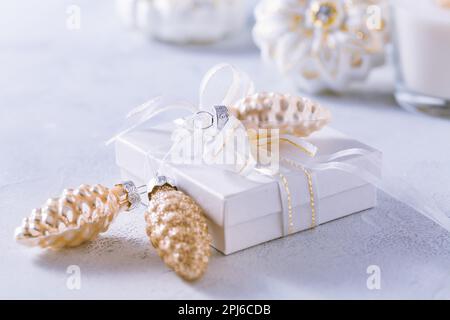 Sistemazione di ornamenti natalizi, candele e regalo di smal in bianco nevoso con spazio copia Foto Stock