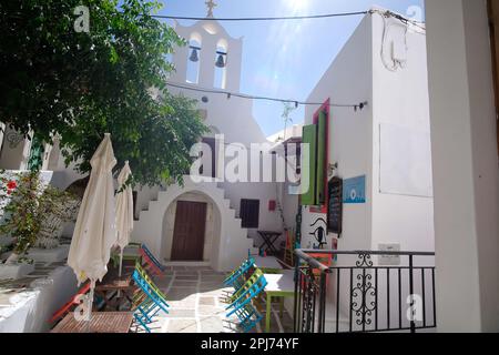 IOS, Grecia - 26 maggio 2021 : Vista di un ristorante pittoresco vicino a una piccola chiesa ortodossa in Grecia iOS Foto Stock