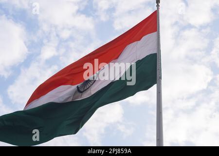 Bandiera dell'India che vola in alto a Connaught Place con orgoglio nel cielo blu, bandiera dell'India che sbatte, bandiera indiana il giorno dell'indipendenza e il giorno della Repubblica dell'India, ti Foto Stock