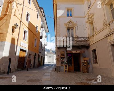 La Signora cammina su una strada pittoresca nella città di Aosta con alle spalle la Cattedrale di Santa Maria Assunta, Valle d'Aosta, Italia. Foto Stock