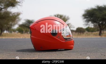 Casco per motociclette sopra isolato su fondo autostrada con percorso di ritaglio Foto Stock