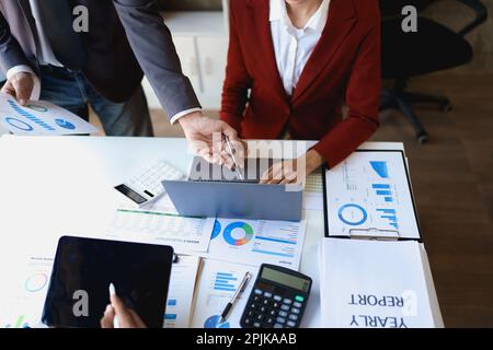 Riunione del consulente aziendale del team per analizzare e discutere la situazione sul rapporto finanziario nella sala riunioni con l'utilizzo di computer portatile, documenti Foto Stock