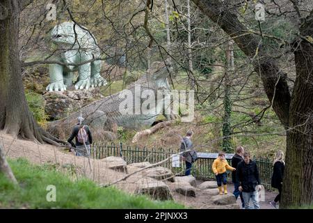 I visitatori possono ammirare le sculture di dinosauri, patrimonio dell'umanità dell'epoca vittoriana di grado i, a Crystal Palace Park, il 3rd aprile 2023, a Londra, in Inghilterra. Crystal Palace Park ha ricevuto £304.000 dal National Lottery Heritage Fund per contribuire al miglioramento e al restauro della sua “isola dei dinosauri”, dove 30 pterodattili, un megalosauro e sculture di iguanodoni sono stati creati solo 10 anni dopo la coniazione del termine “dinosauro”, E sette anni prima che Charles Darwin pubblicasse la sua teoria dell'evoluzione. Foto Stock