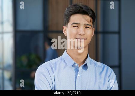 primo piano ritratto fotografico di felice uomo d'affari asiatico capo, uomo che guarda la fotocamera Foto Stock