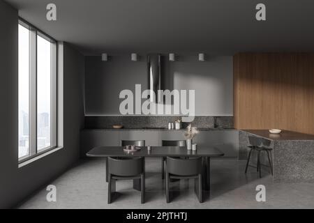 Interno cucina casa scura con angolo cottura e zona pranzo, bar isola con sedia. Moderno design della zona pranzo, pavimento in cemento grigio. Finestra panoramica su sk Foto Stock