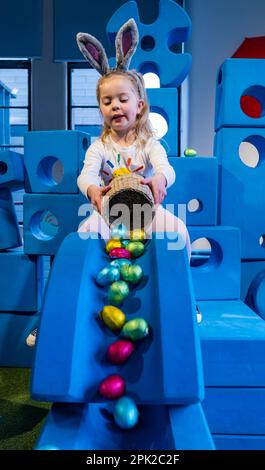 City Art Centre, Edimburgo, Scozia, Regno Unito, 05 aprile 2023. Edinburgh Science Festival: I bambini si preparano per Pasqua rotolando le colorate uova di Pasqua giù per uno scivolo costruito da blocchi di costruzione dall'installazione Imagination Playground. Il City Art Centre dispone di cinque piani di laboratori scientifici pratici e attività ed è il principale luogo di ritrovo per famiglie del Festival, che offre divertimento educativo per tutta la giornata per i bambini tra i 3 e i 12 anni. Nella foto: Dorothy, 4 anni di esperienza con uova di Pasqua e uno scivolo. Credit: Sally Anderson/Alamy Live News Foto Stock